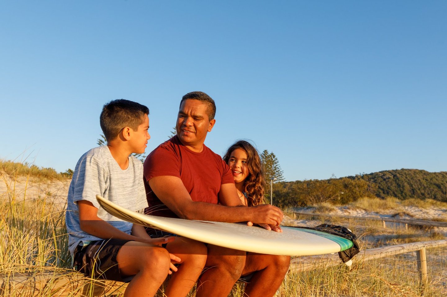 father with kids and surfboard iStock-1025084848