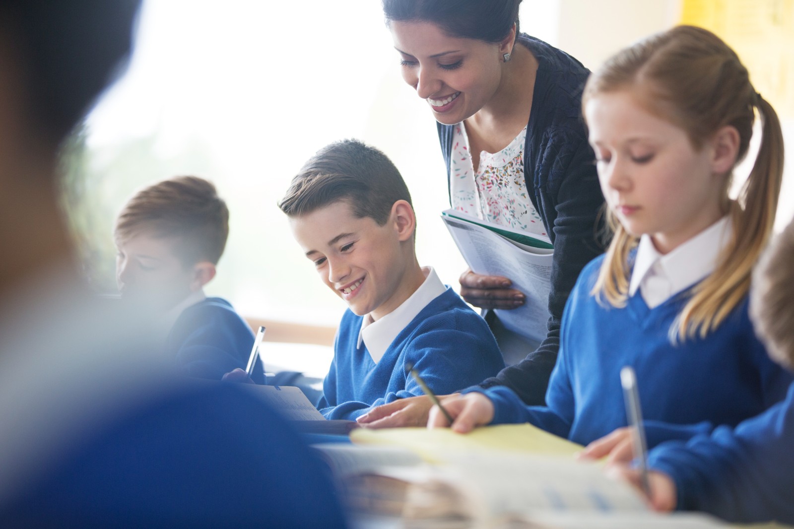 teacher and students writing iStock-534575877